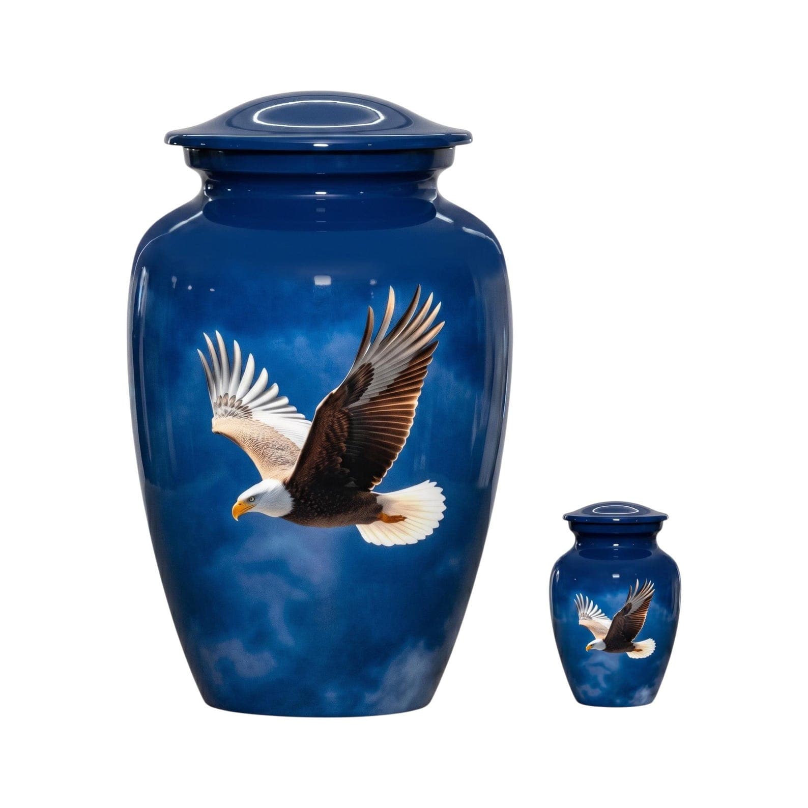 A large and a small blue cremation urn, both featuring a glossy finish and a detailed graphic of a bald eagle in flight against a cloudy sky. Each urn has a matching removable lid and a rounded, tapered body shape.